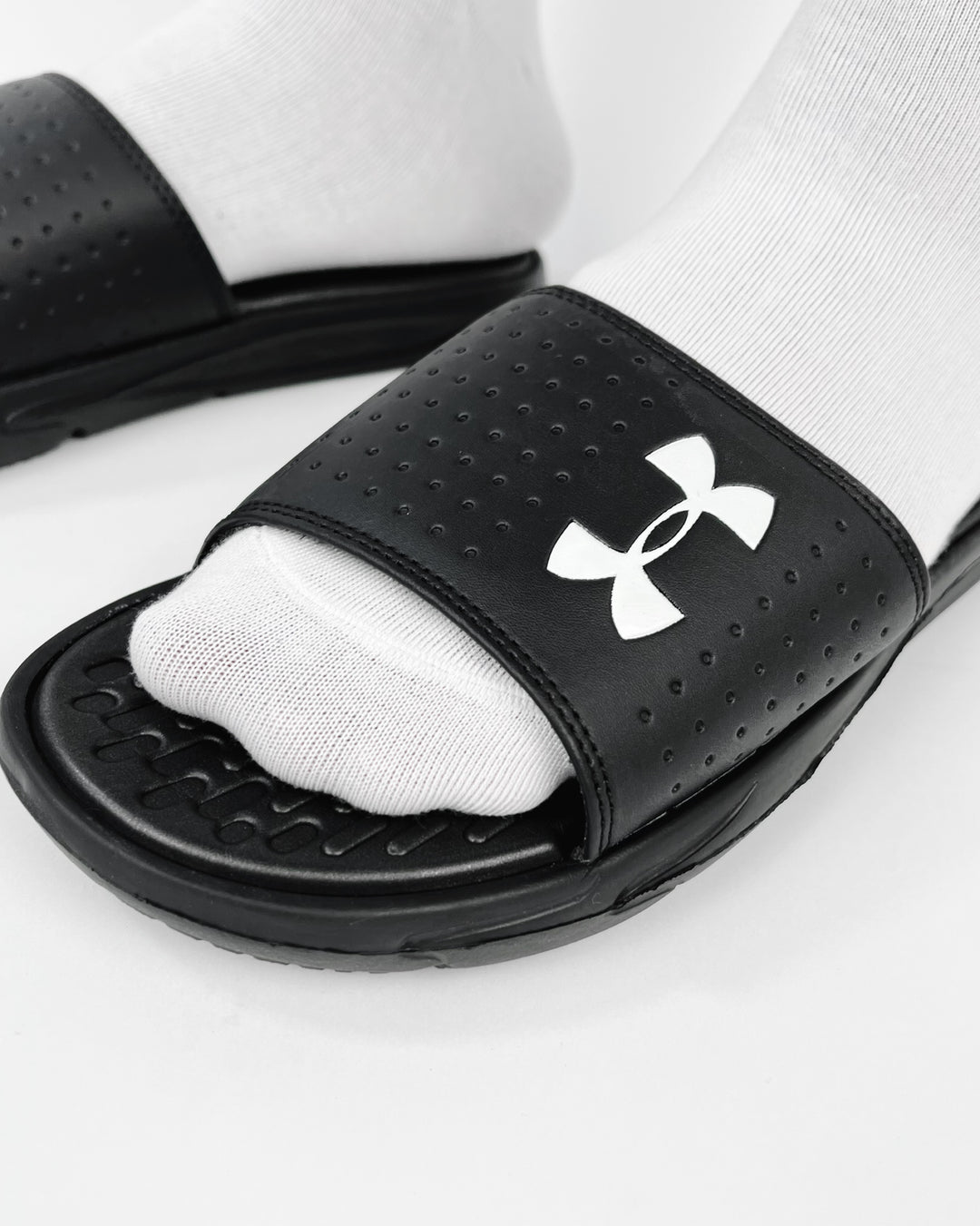 Under Amour Playmaker Slides in black & white