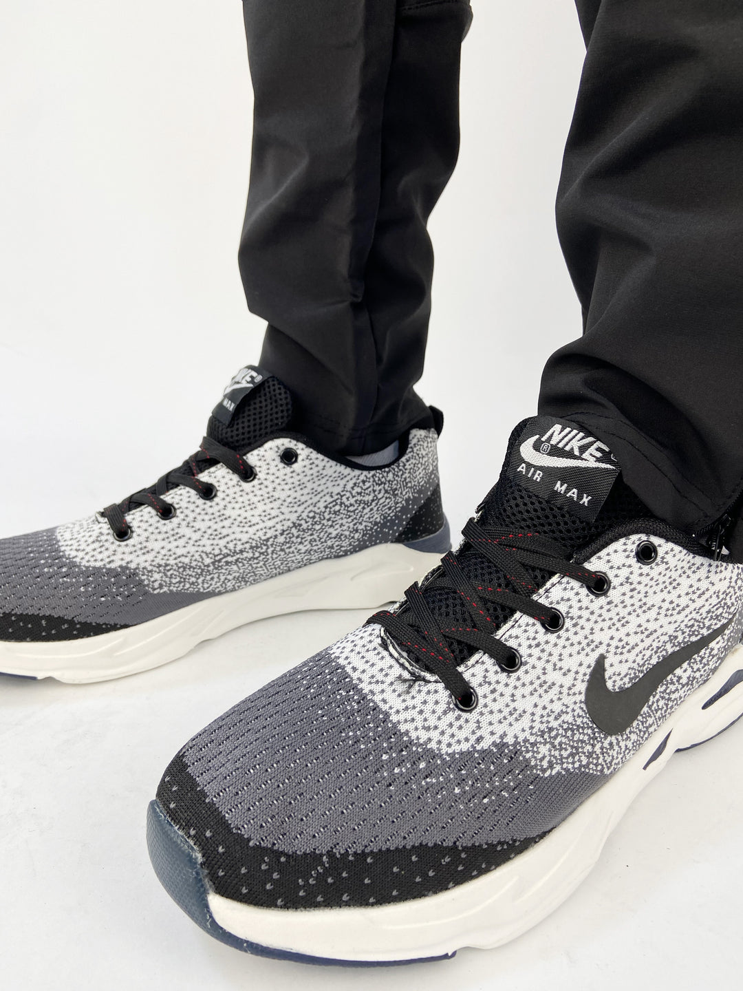 Nike air max trainers in black and white spots with blue soles