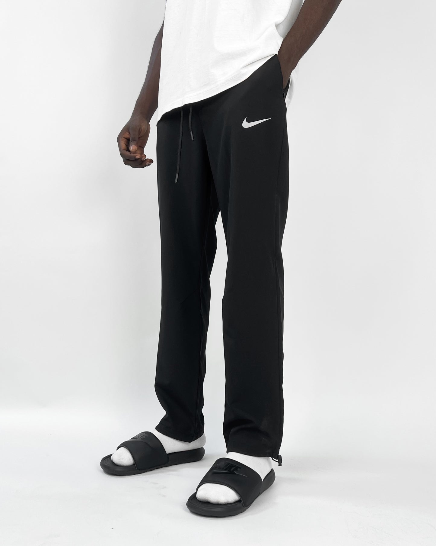Nike reflective logo track pants in black Garmisland