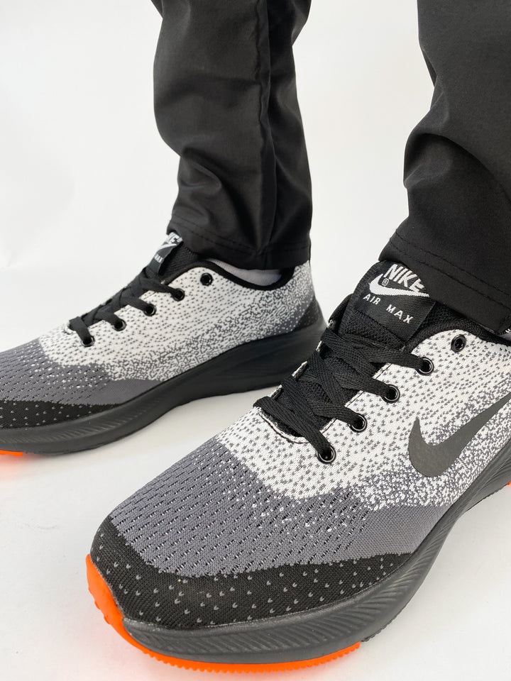 Nike air max trainers in black and white spots with orange soles