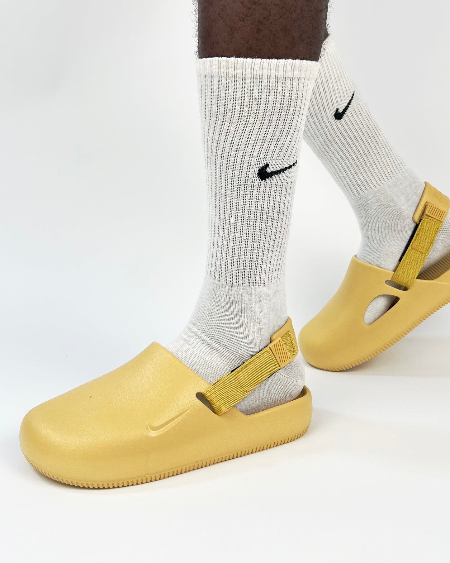 Nike Calm Mule Slides in Mustard Garmisland