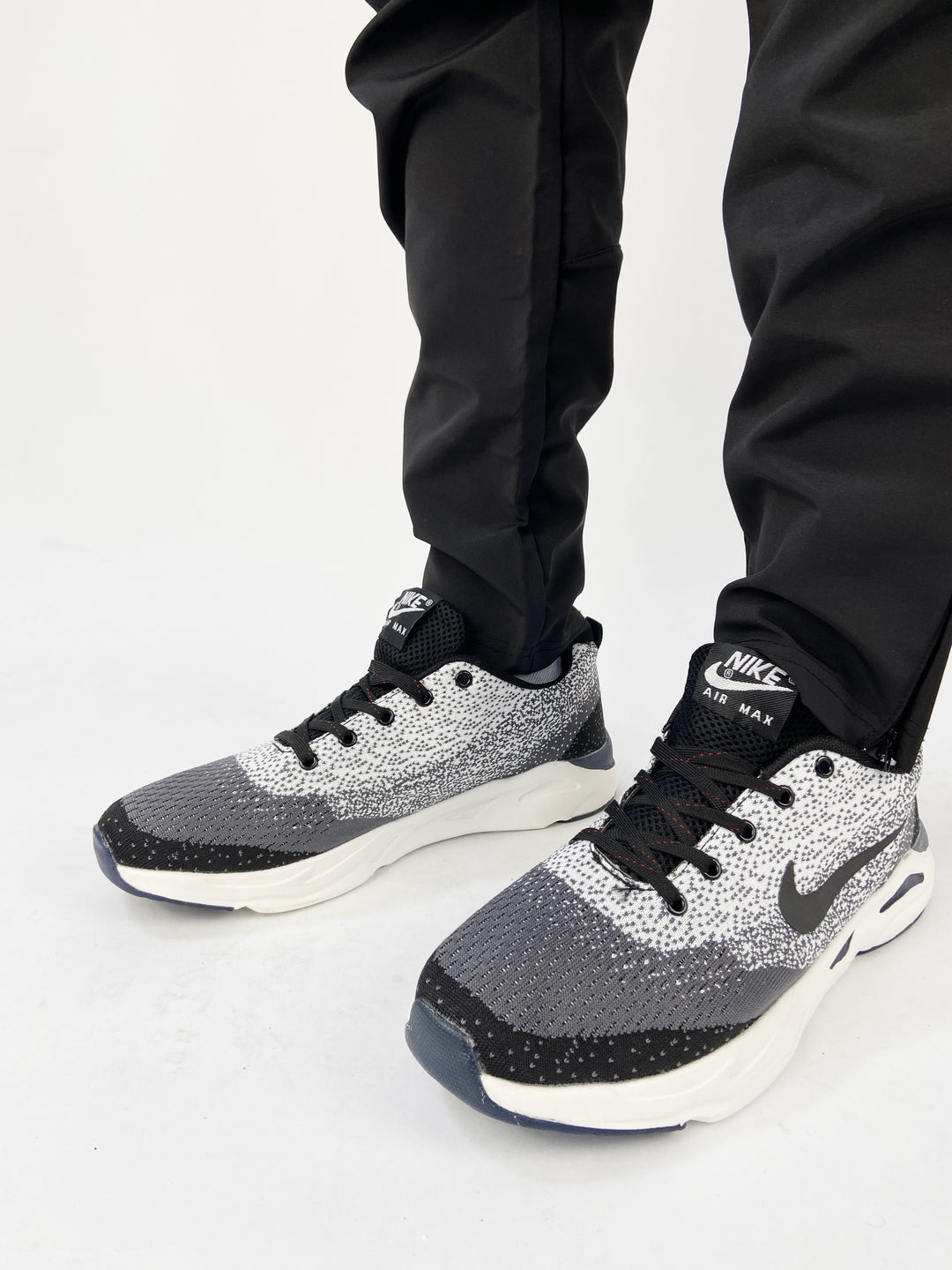 Nike air max trainers in black and white spots with blue soles