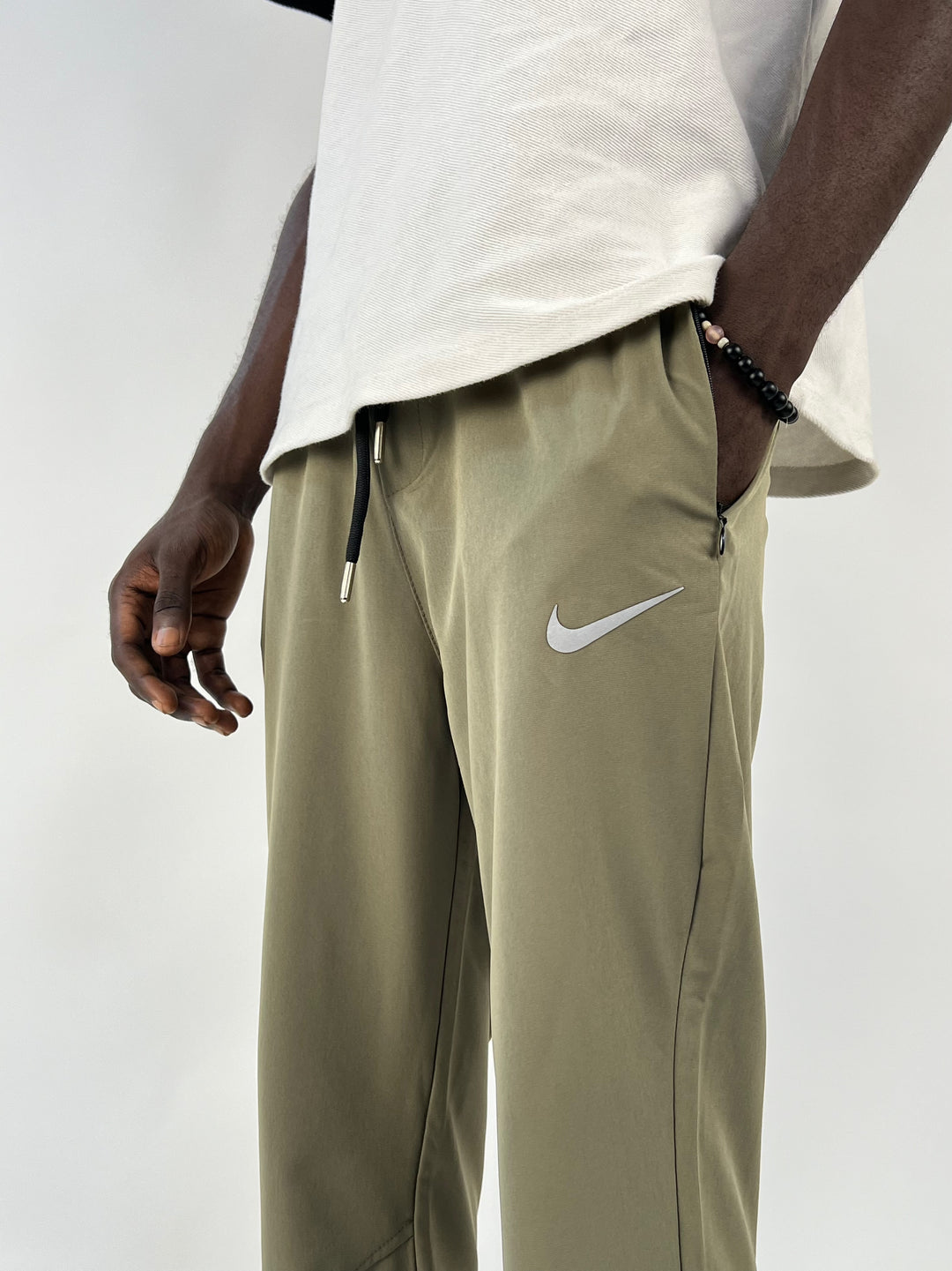 Nike reflective logo track pants in green