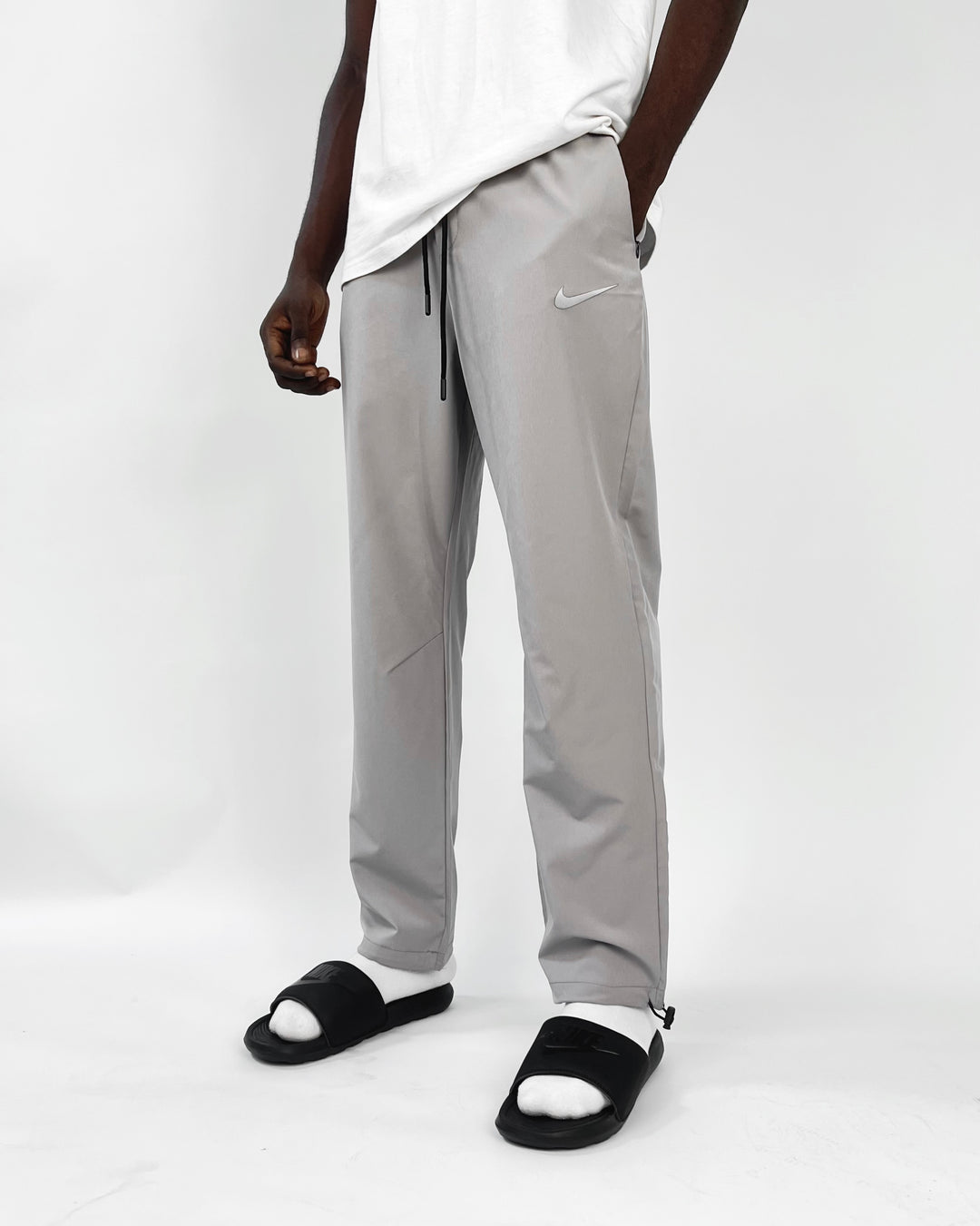 Nike reflective logo track pants in dark gray