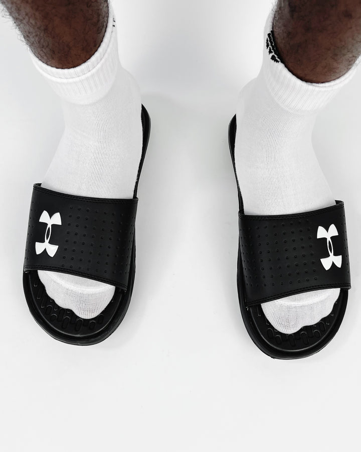 Under Amour Playmaker Slides in black & white