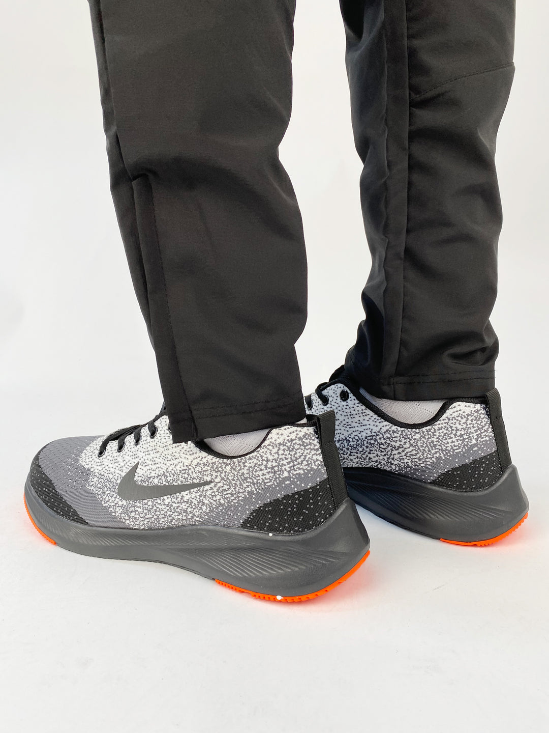 Nike air max trainers in black and white spots with orange soles