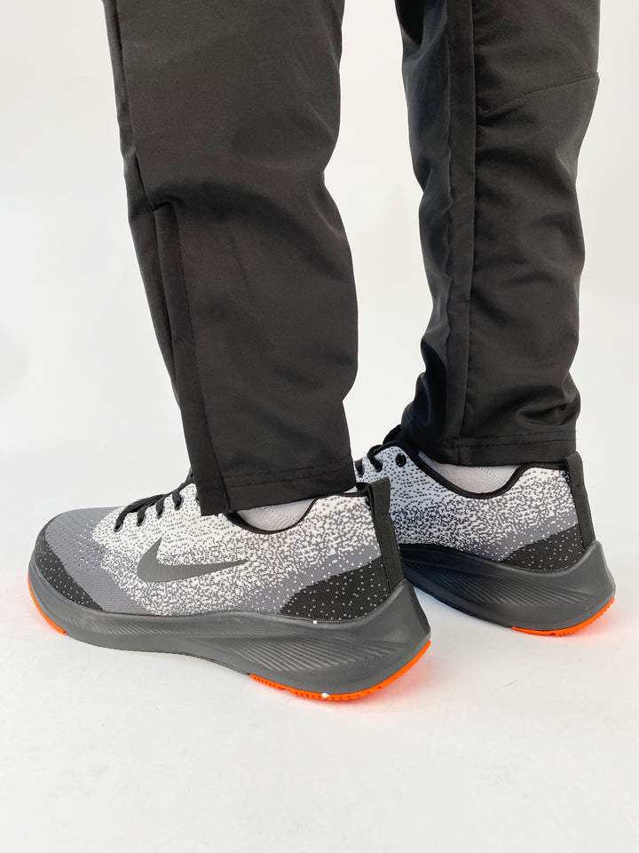 Nike air max trainers in black and white spots with orange soles