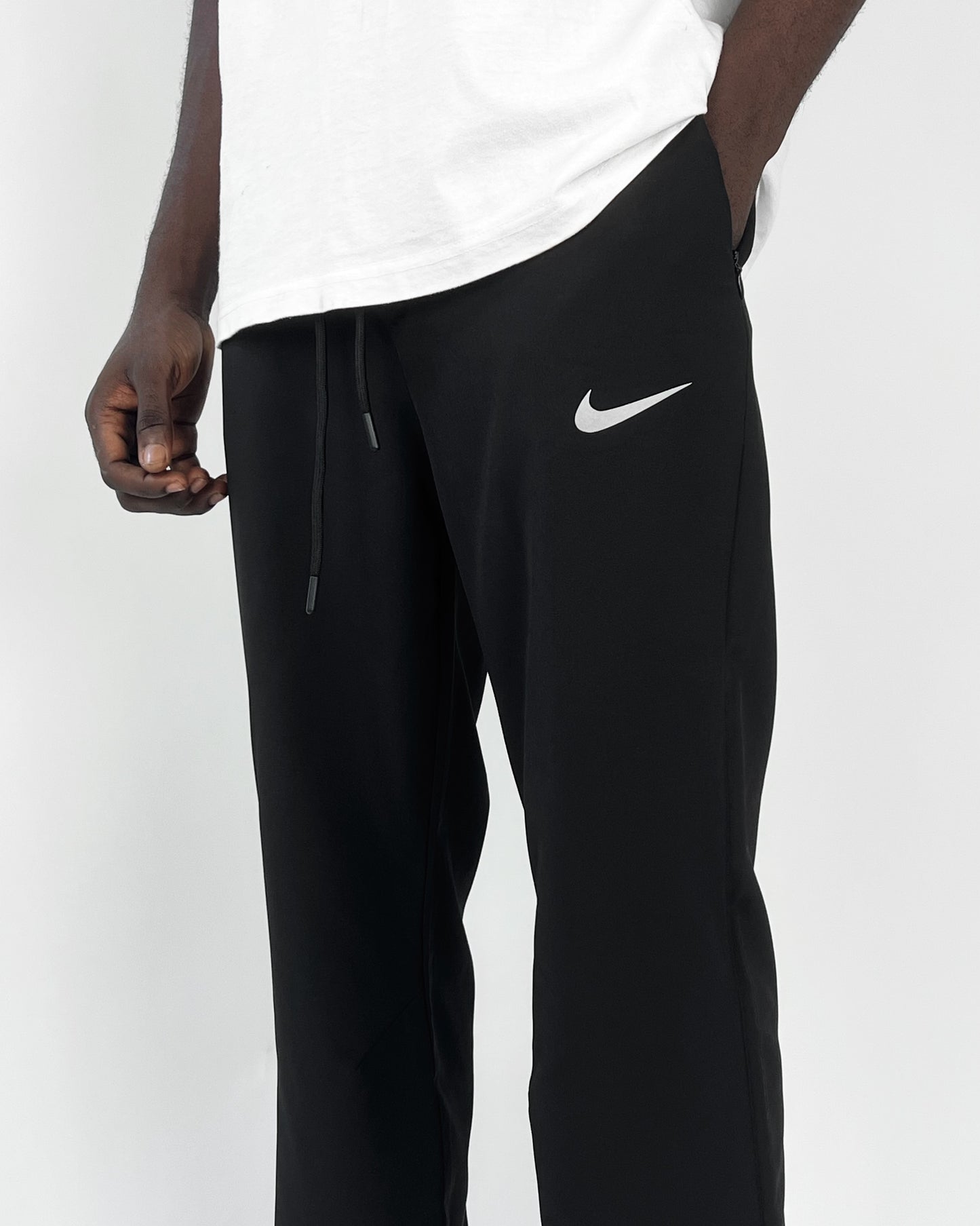 Nike reflective logo track pants in black Garmisland