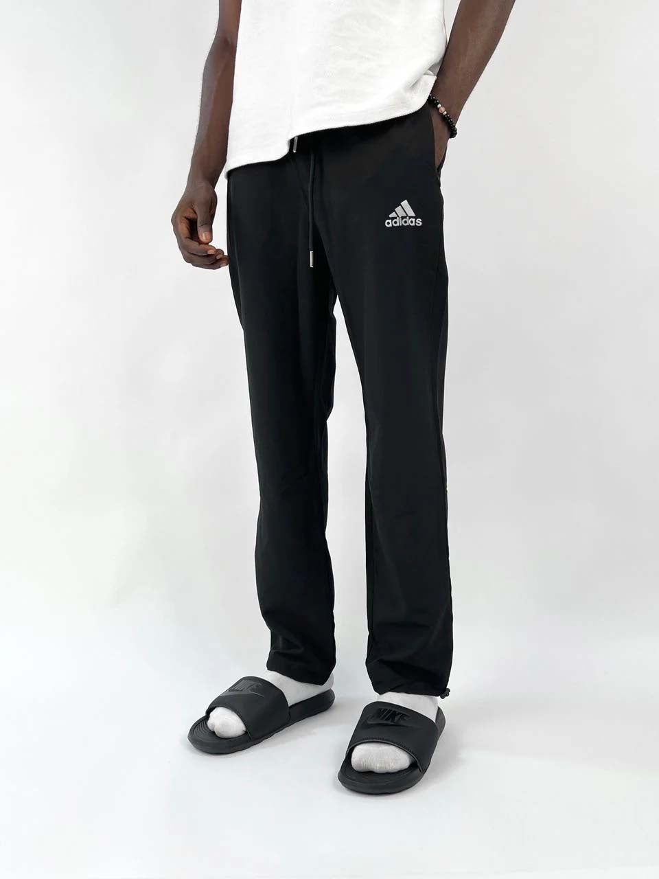 Adidas reflective logo track pants in black