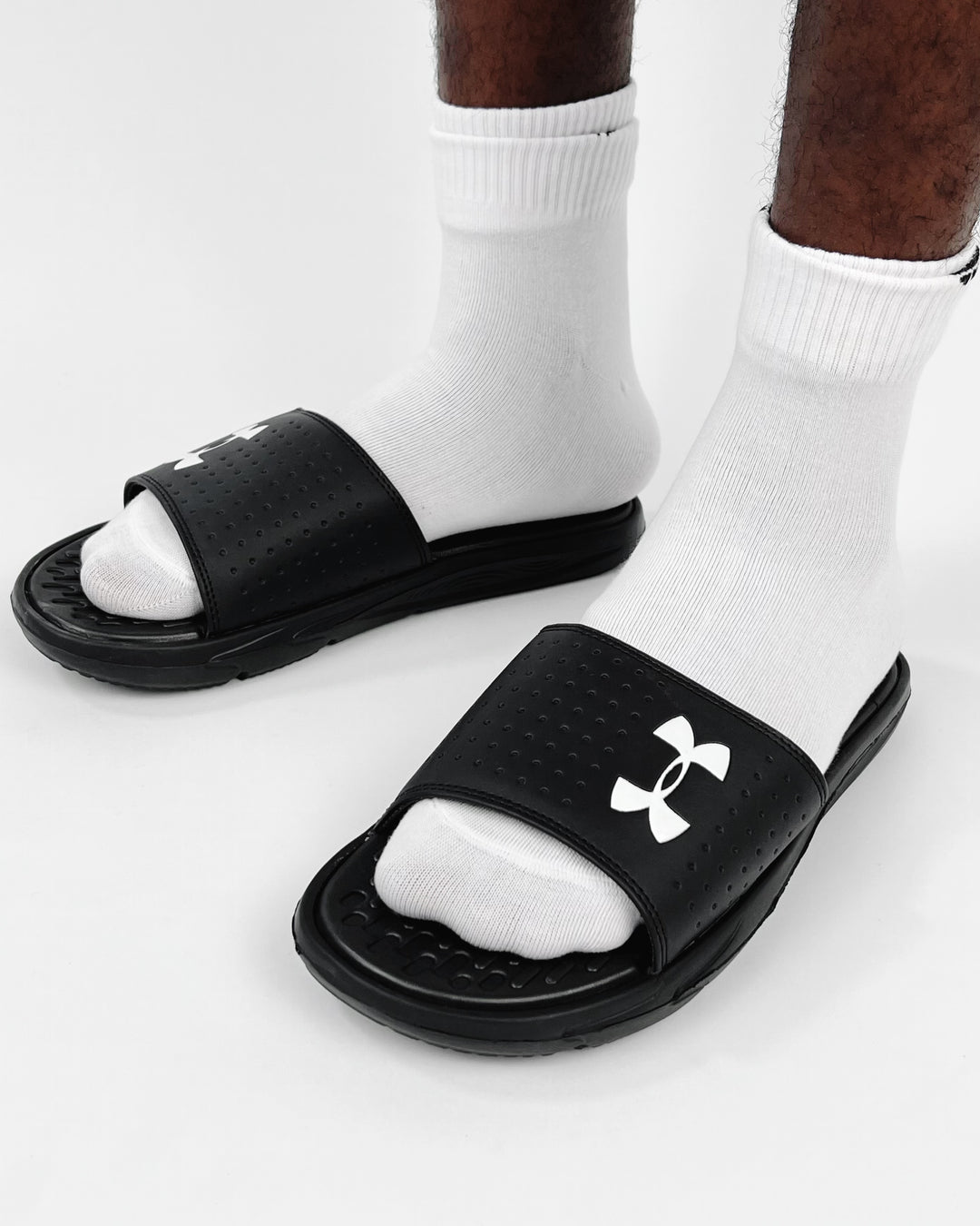 Under Amour Playmaker Slides in black & white