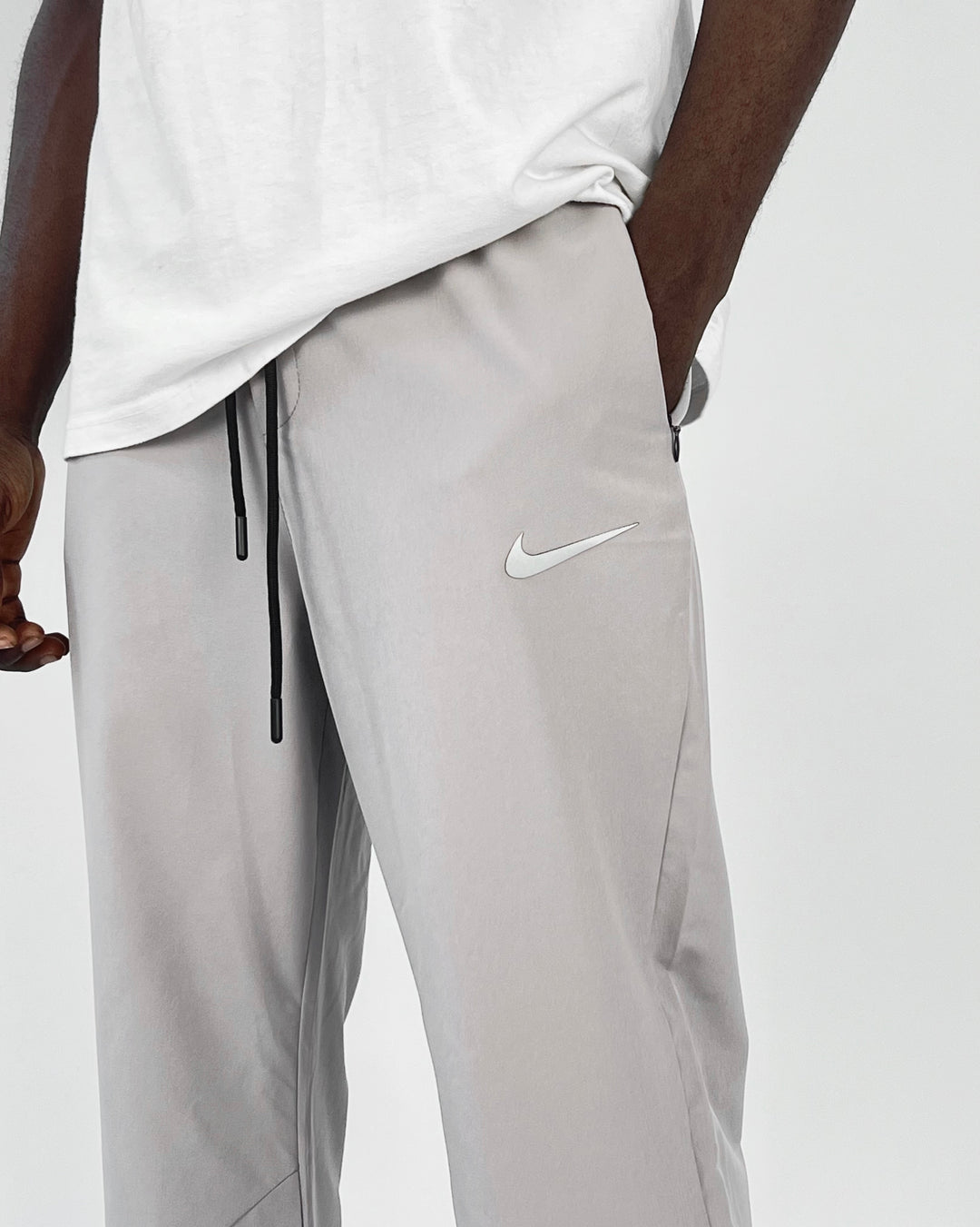 Nike reflective logo track pants in dark gray