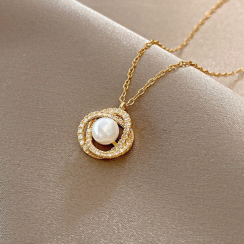 Round pearl cross pendant necklace in gold
