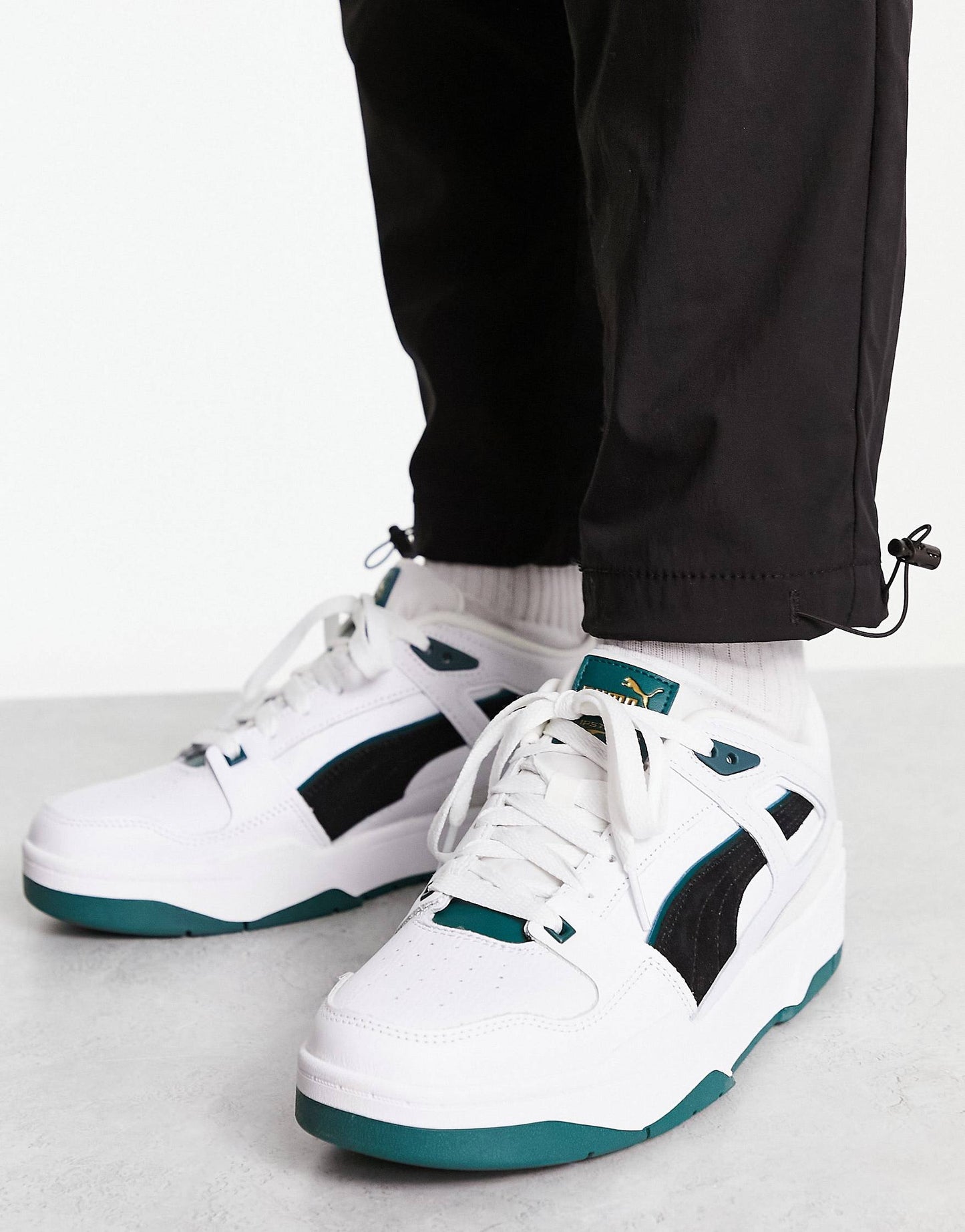 Puma slipstream trainers in white with black and green suede detail
