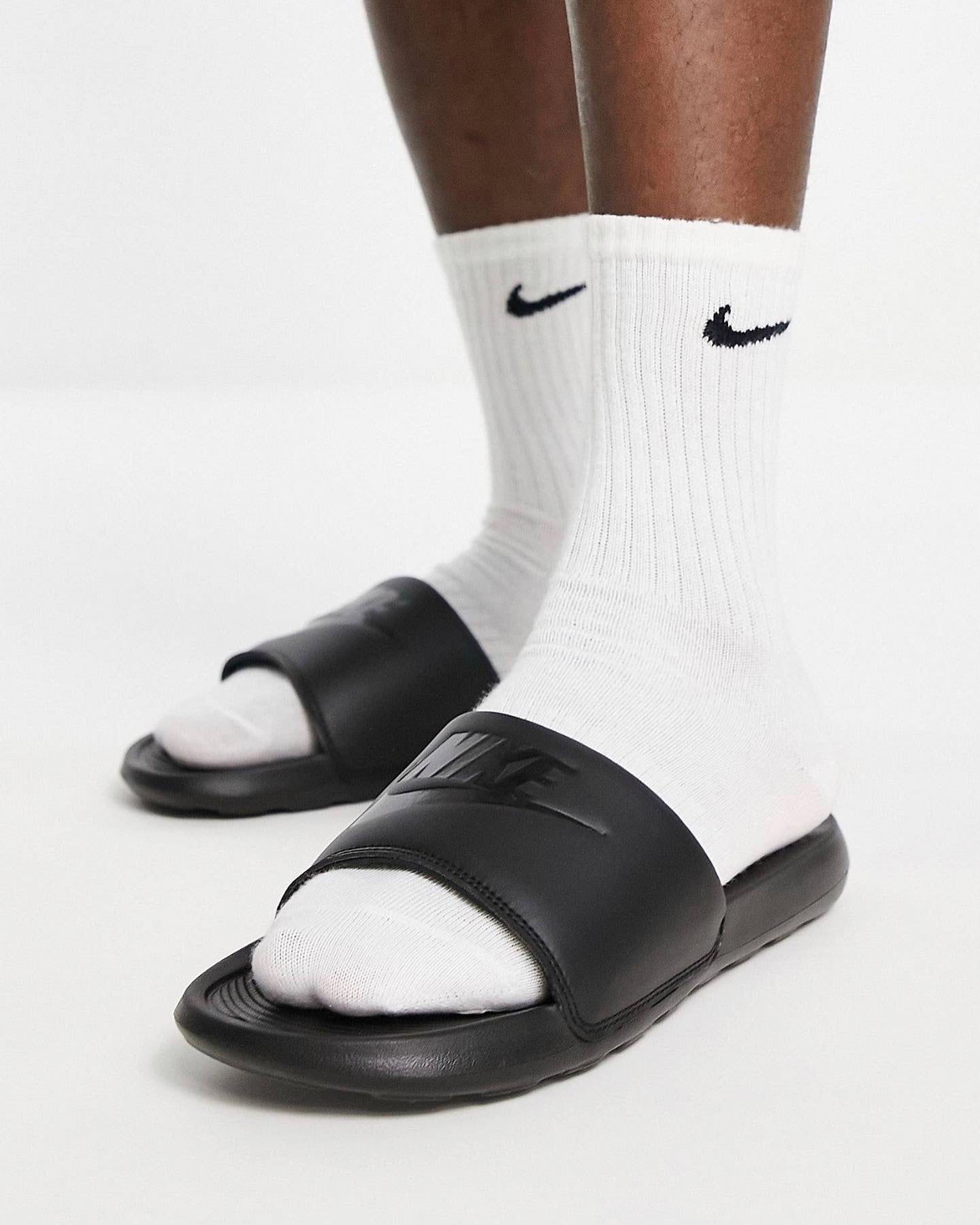 All black nike store sliders